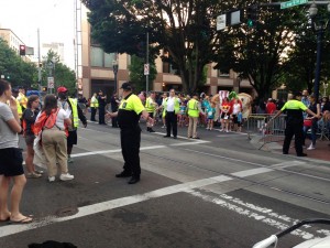 The Starlight Run and Parade holds for a moment as TriMet buses and trains are allowed to cross at W. 5th and Burnside.