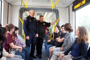 Transit Police Commander Mike Leloff (left) and Milwaukie Police Chief Steve Bartol (right) talk with students about the MAX Orange Line and safe behavior around trains.