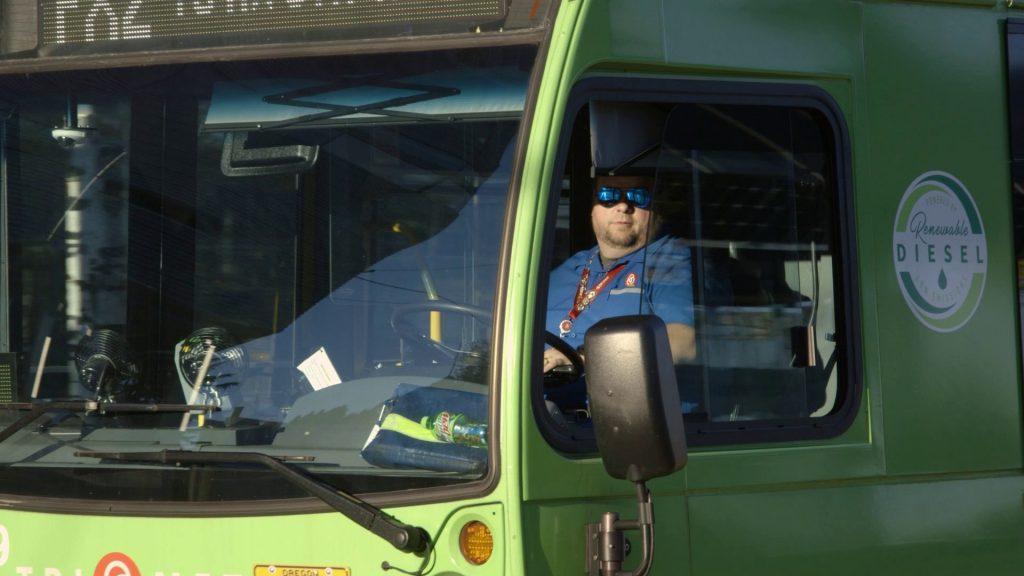 Image of a TriMet FX2-Division bus operator at the wheel.