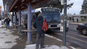 Image of TriMet riders boarding a TriMet bus in the snow.