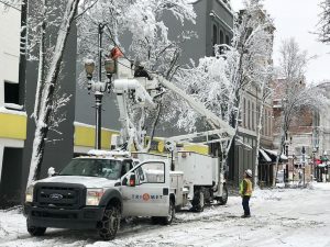 Image of a TriMet utility truck and crew working on overhead power lines in Portland.