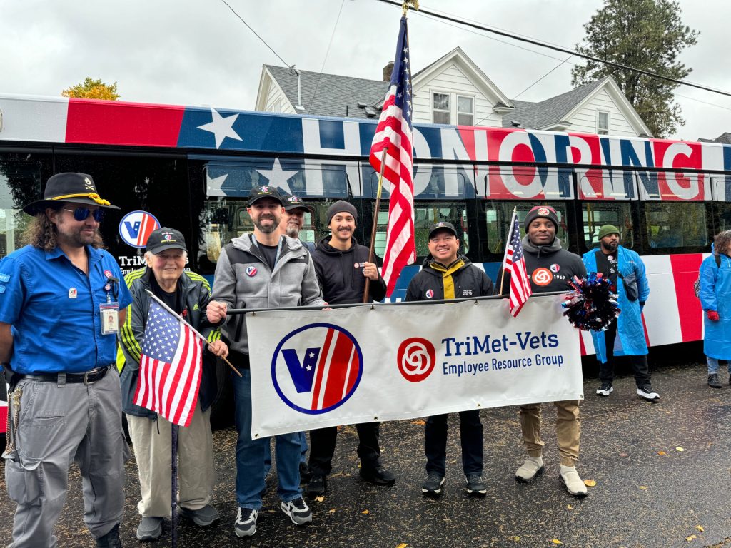 TriMet-Vets Employee Resource Group members pose in front of TriMet's Veterans Day bus.