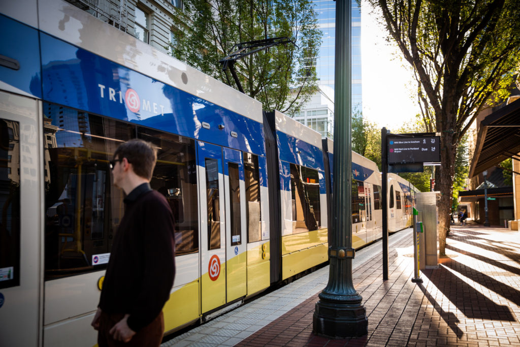 Image of a person preparing to board a TriMet MAX train at Pioneer Square in Downtown Portland.